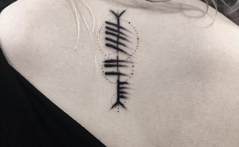 Upper back ogham tattoo “Saor” meaning “Free”